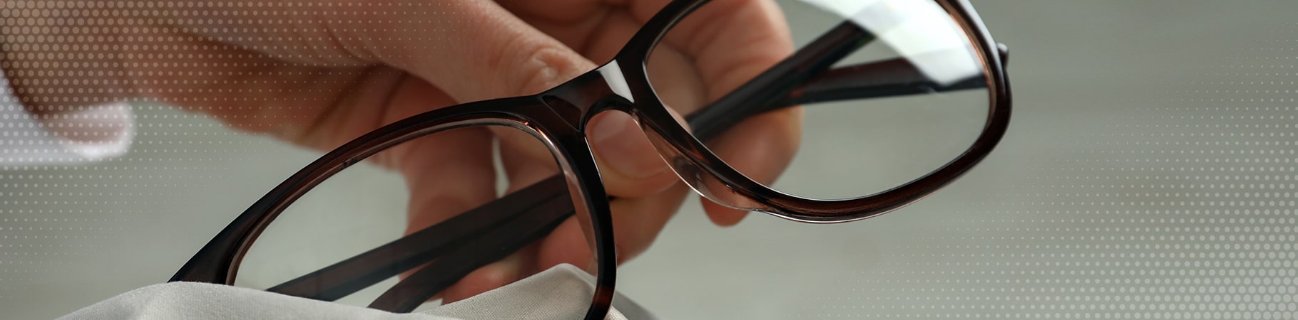 holding black framed glasses